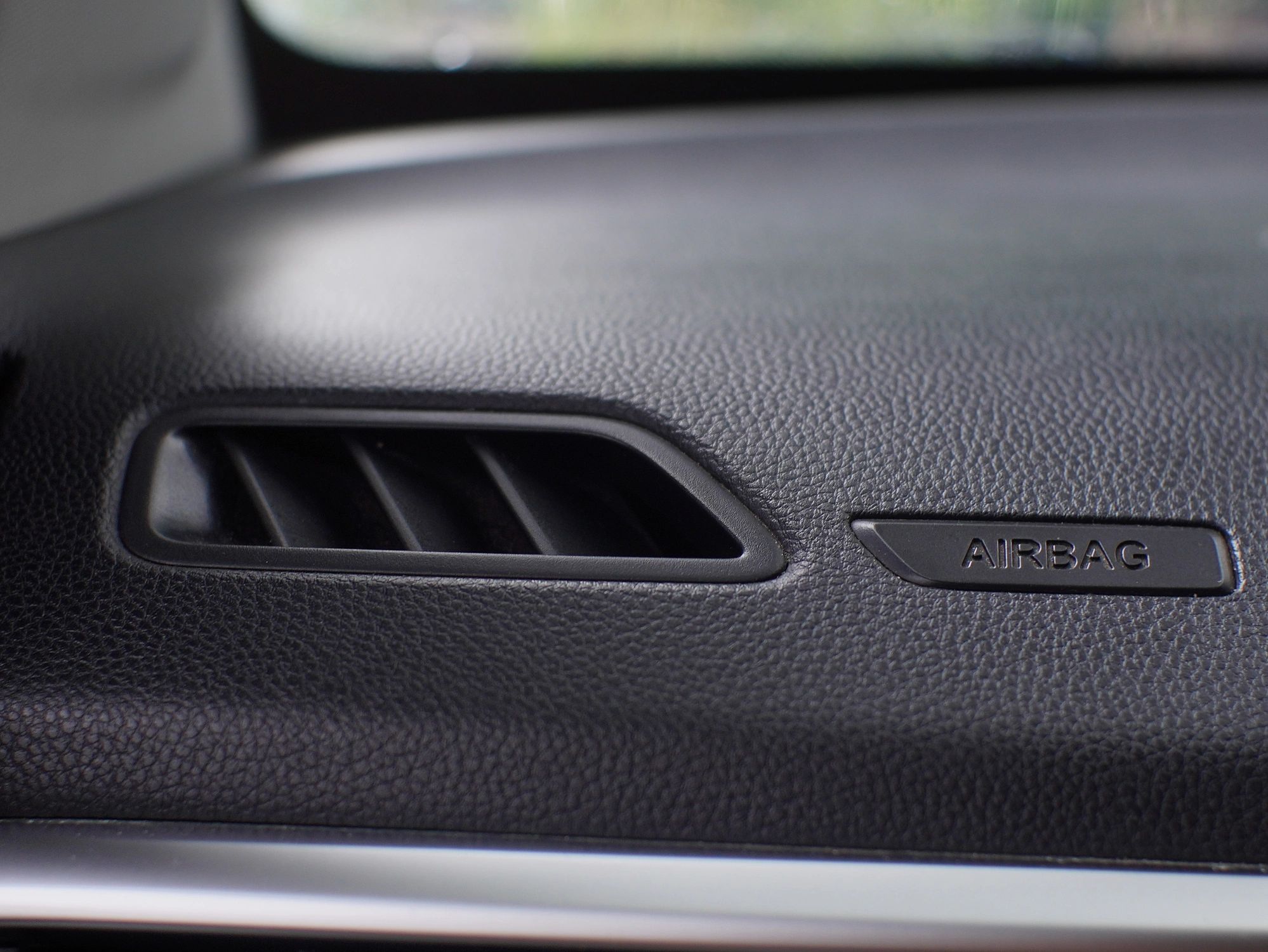 Clean modern vehicle dashboard and interior surfaces after detailing